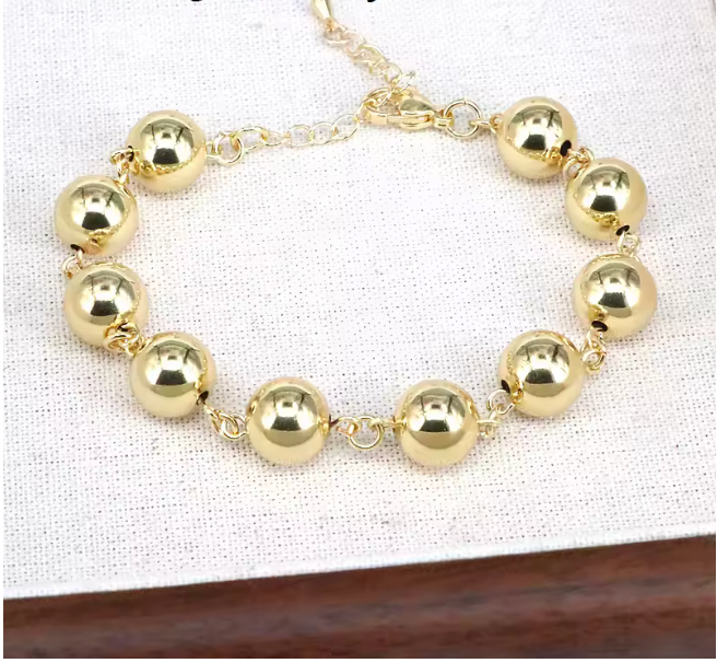 89124340 Pulsera de esferas doradas en oro laminado 18k (3 Capas)